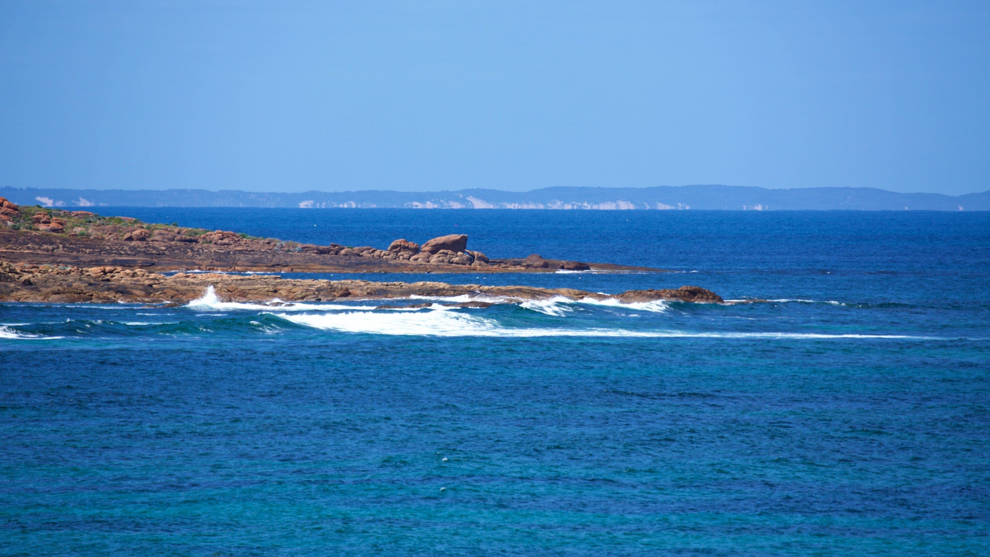 Cape Leeuwin Lighthouse featuring waves and rocky coastline