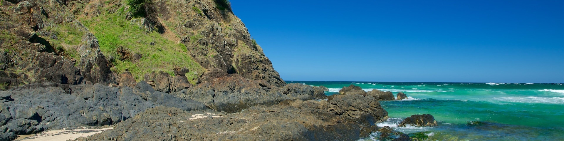 Tallow Beach showing a beach and rugged coastline