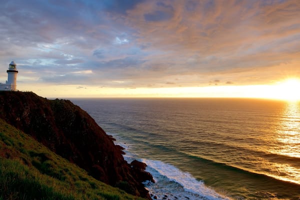 Cape Byron Lighthouse featuring a sunset and rugged coastline