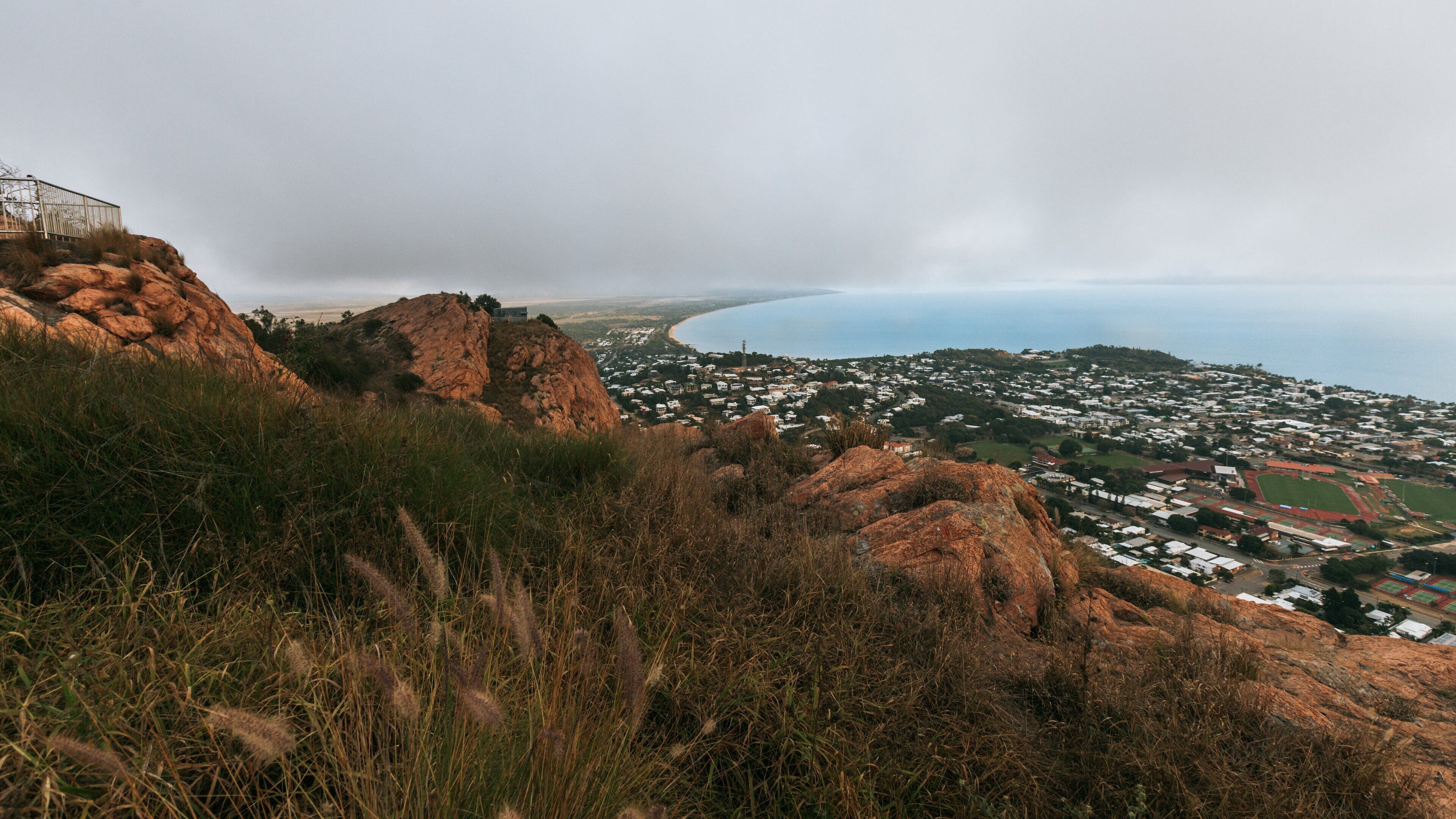 Castle Hill showing a coastal town, landscape views and mist or fog