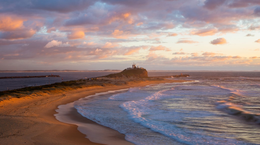 Nobbys Head Beach which includes a sunset and general coastal views