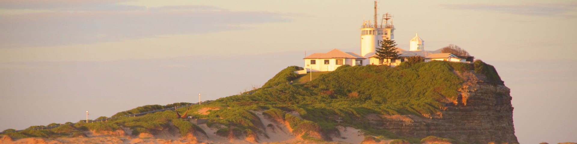 Nobbys Head Beach which includes a lighthouse and a beach