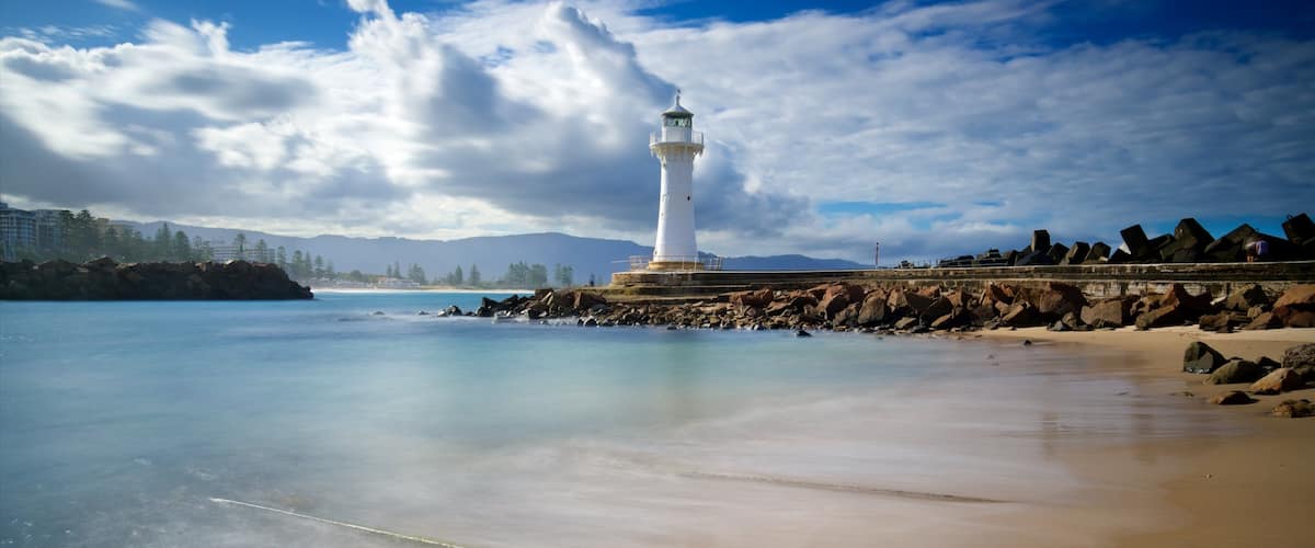 Flagstaff Hill Fort featuring rugged coastline, a sandy beach and a lighthouse