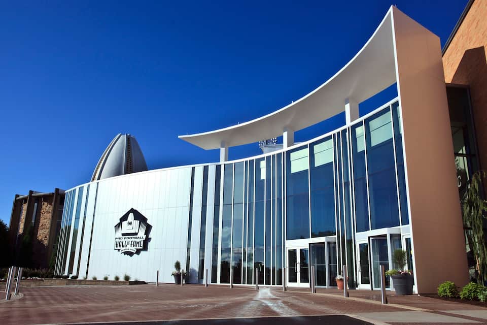 A modern building with a curved roof and a large glass facade.