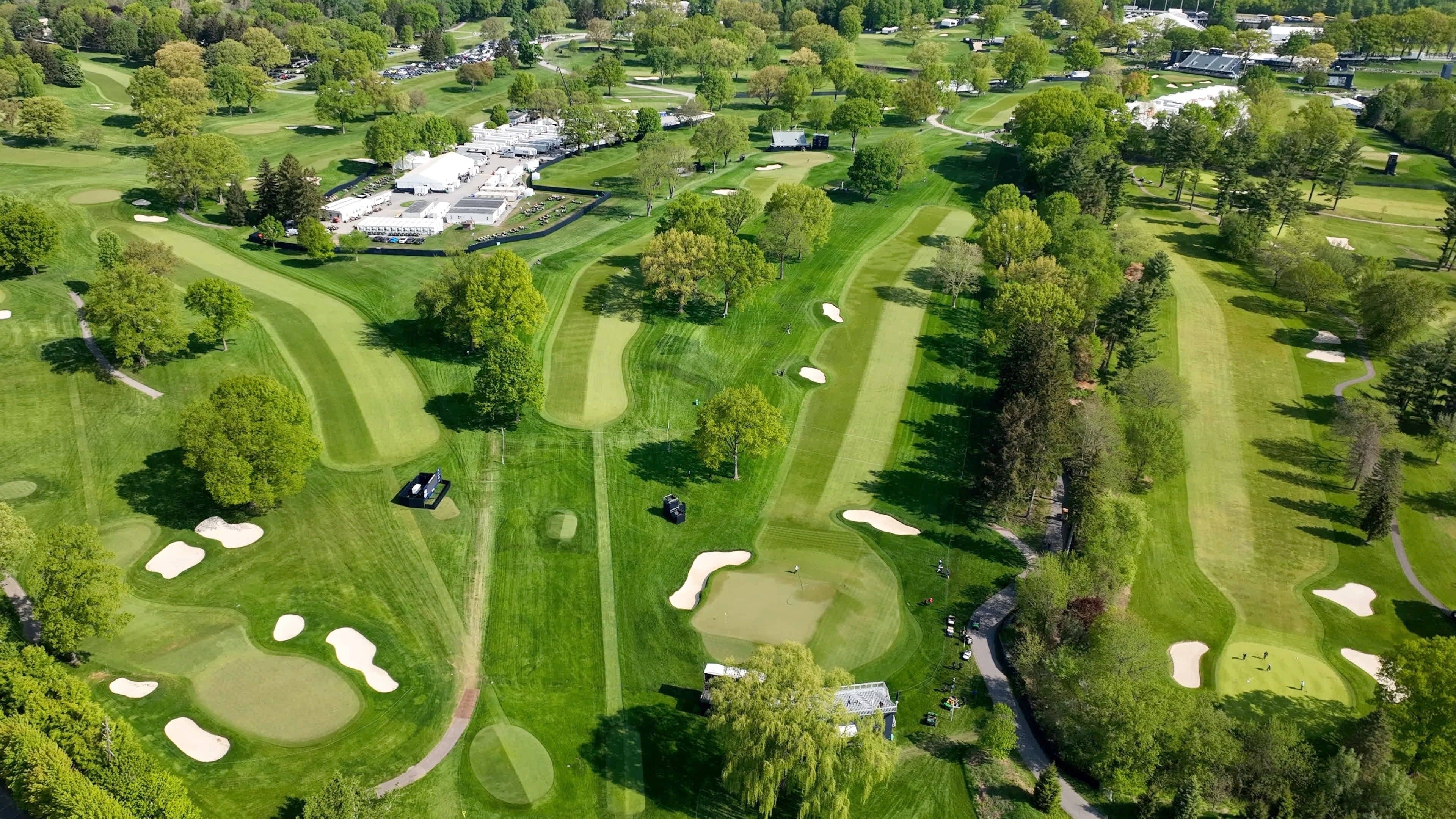 PGA Championship 2023 Golf course with greens and fairways at Oak Hill Country Club Pittsford, NY during morning course prep by staff and media