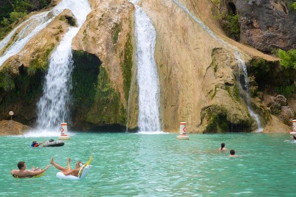 Turner Falls featuring a waterfall, a lake or waterhole and swimming