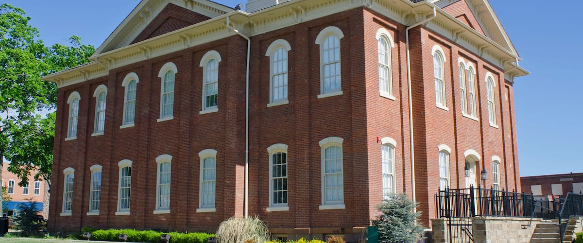 A large red brick building with arched windows and a tower.