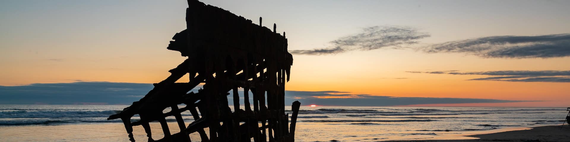 Fort Stevens State Park featuring general coastal views, a sunset and building ruins