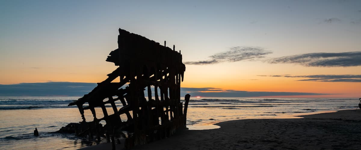 Fort Stevens State Park featuring general coastal views, a sunset and building ruins