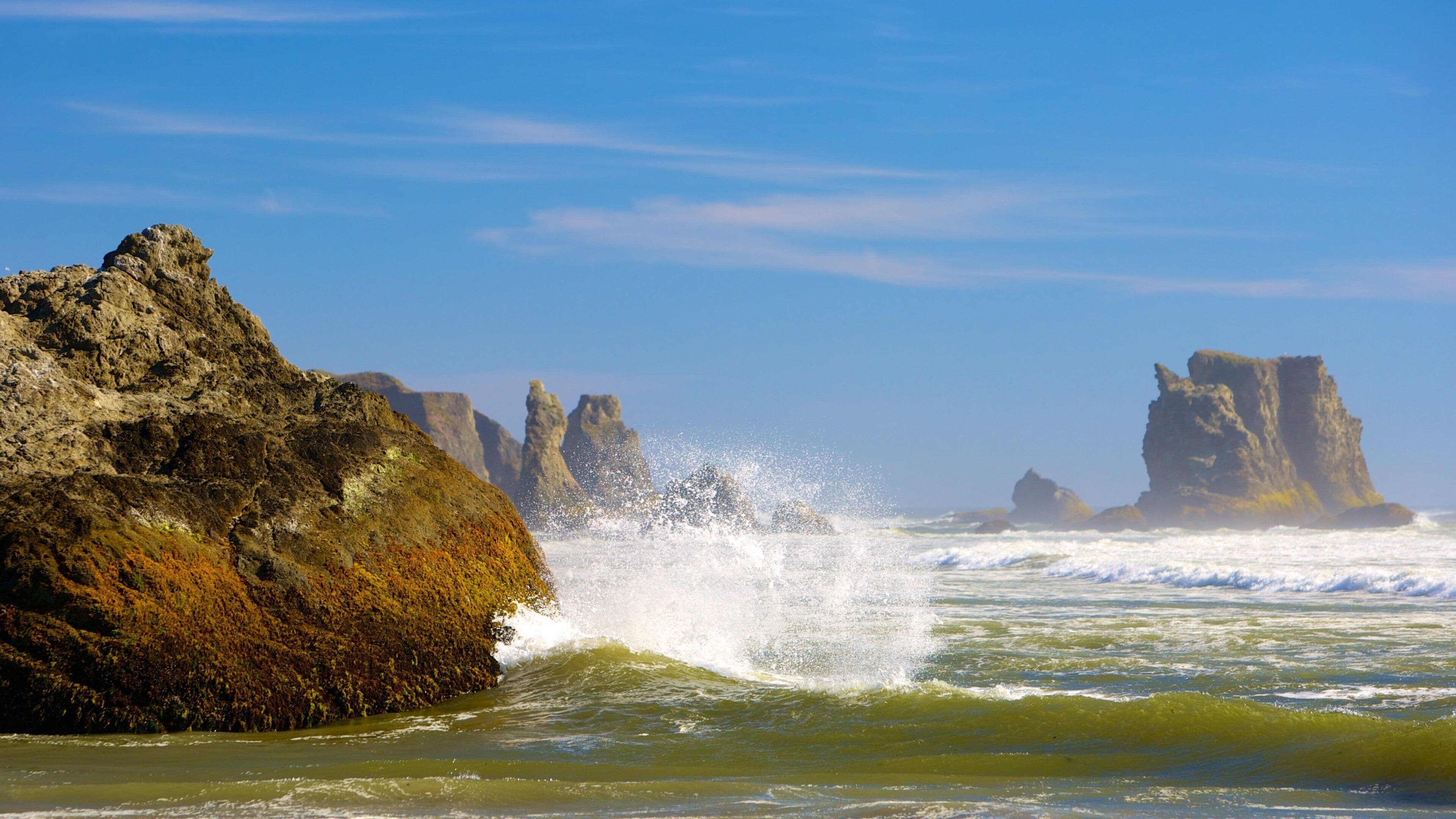 A rocky coastline with waves crashing against the rocks.