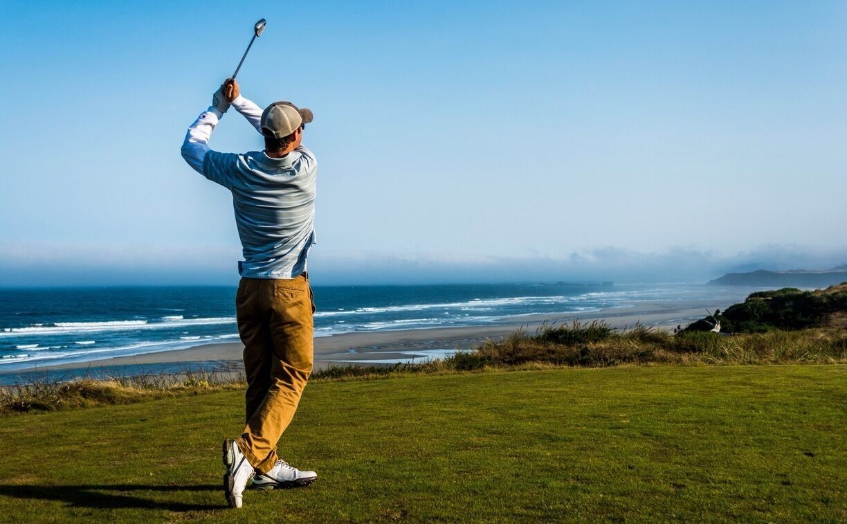 My brother taking a swing at a beautiful course right on the Oregon coast