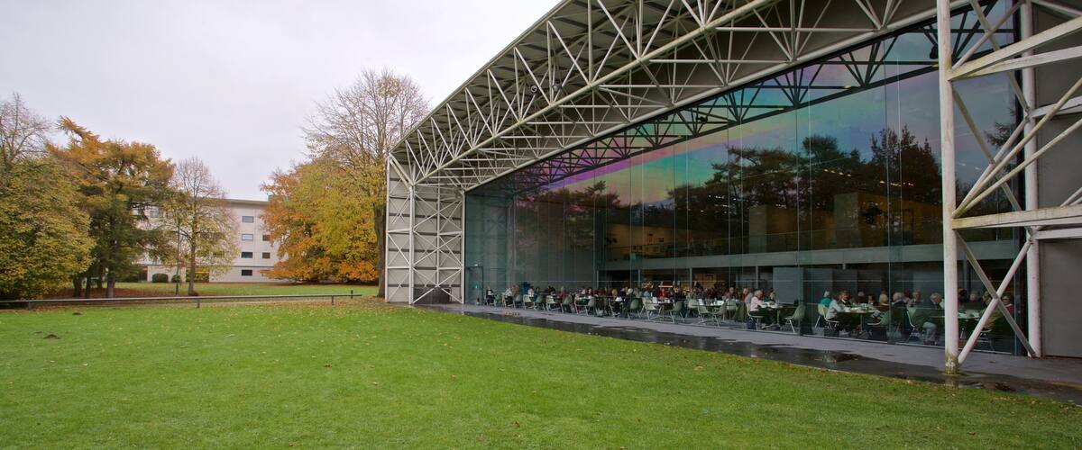 Sainsbury Centre for the Visual Arts featuring a garden and modern architecture as well as a small group of people