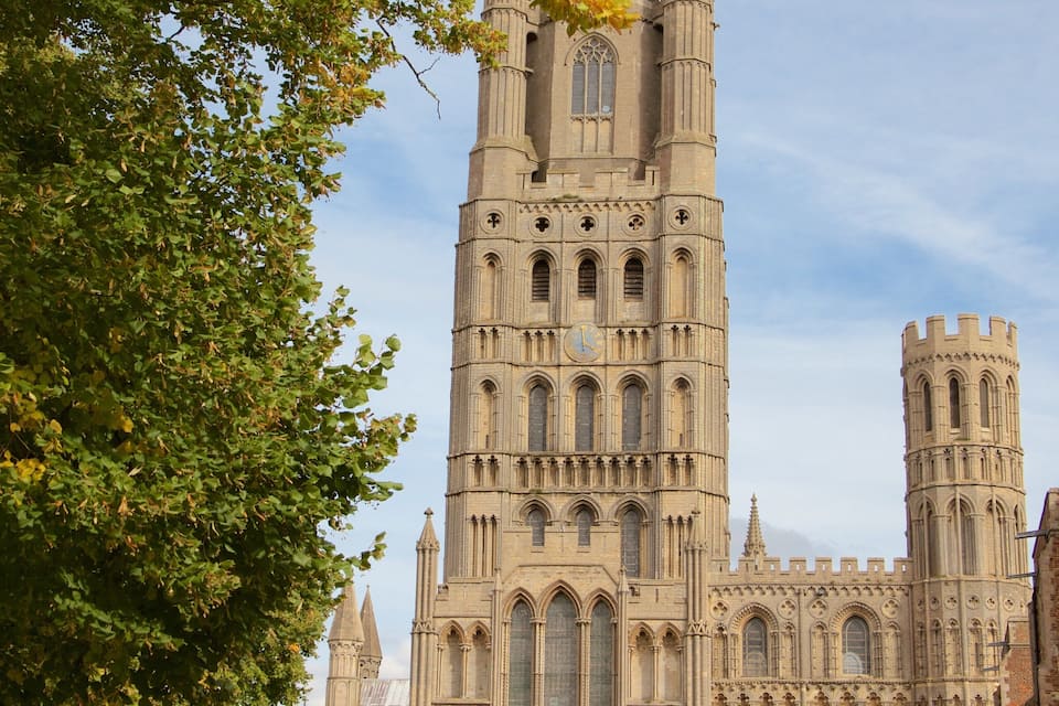 A tall Gothic-style church with a clock tower and spires.