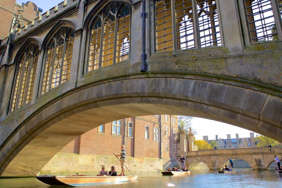 A stone bridge with arched windows and a river underneath.