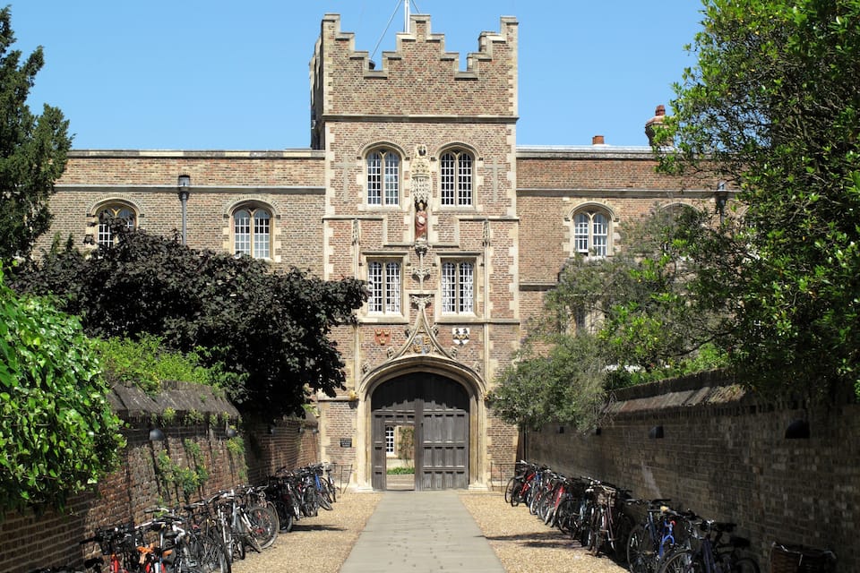 A historic building with a prominent tower and arched windows.