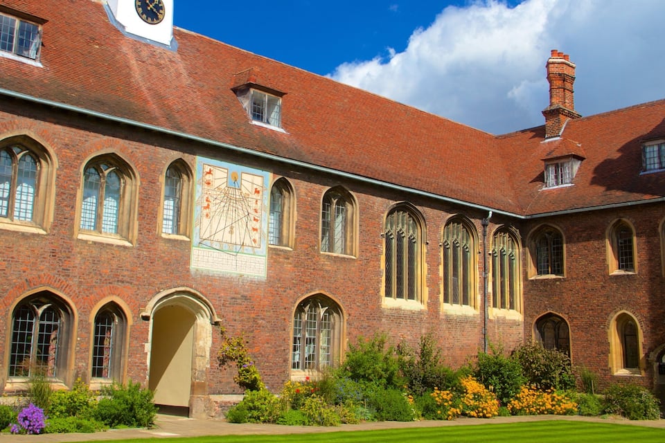 A historic building with arched windows and a large mural.