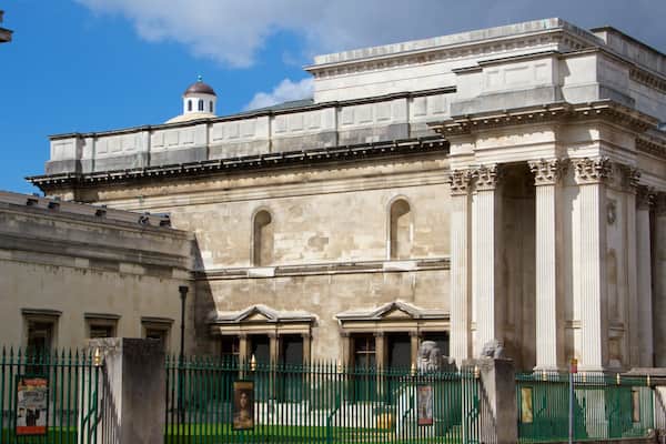 A historic building with classical architecture, including columns and arches.