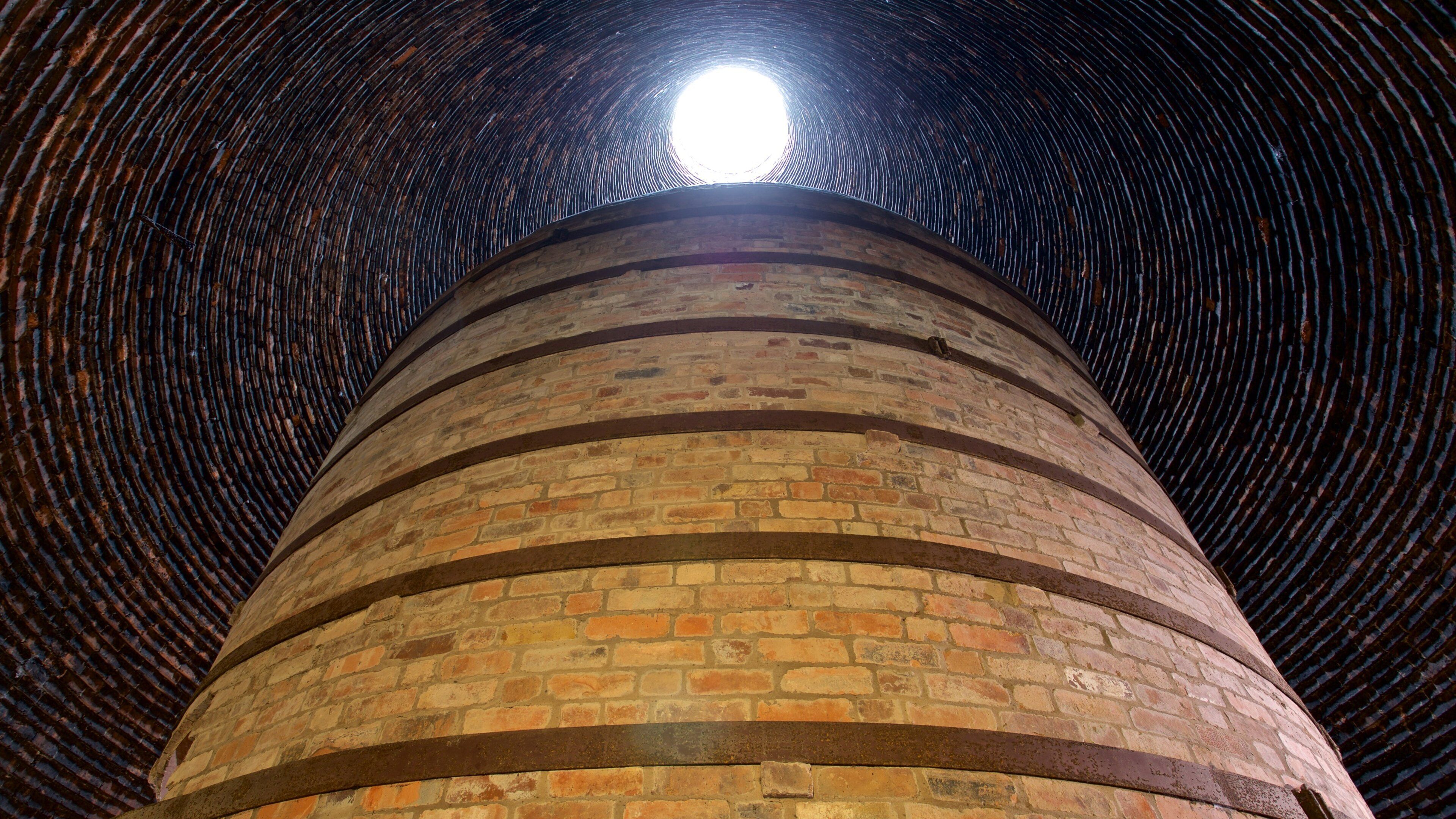 A cylindrical brick structure with a circular opening at the top.