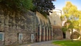A historic stone building with arched windows and a tower.