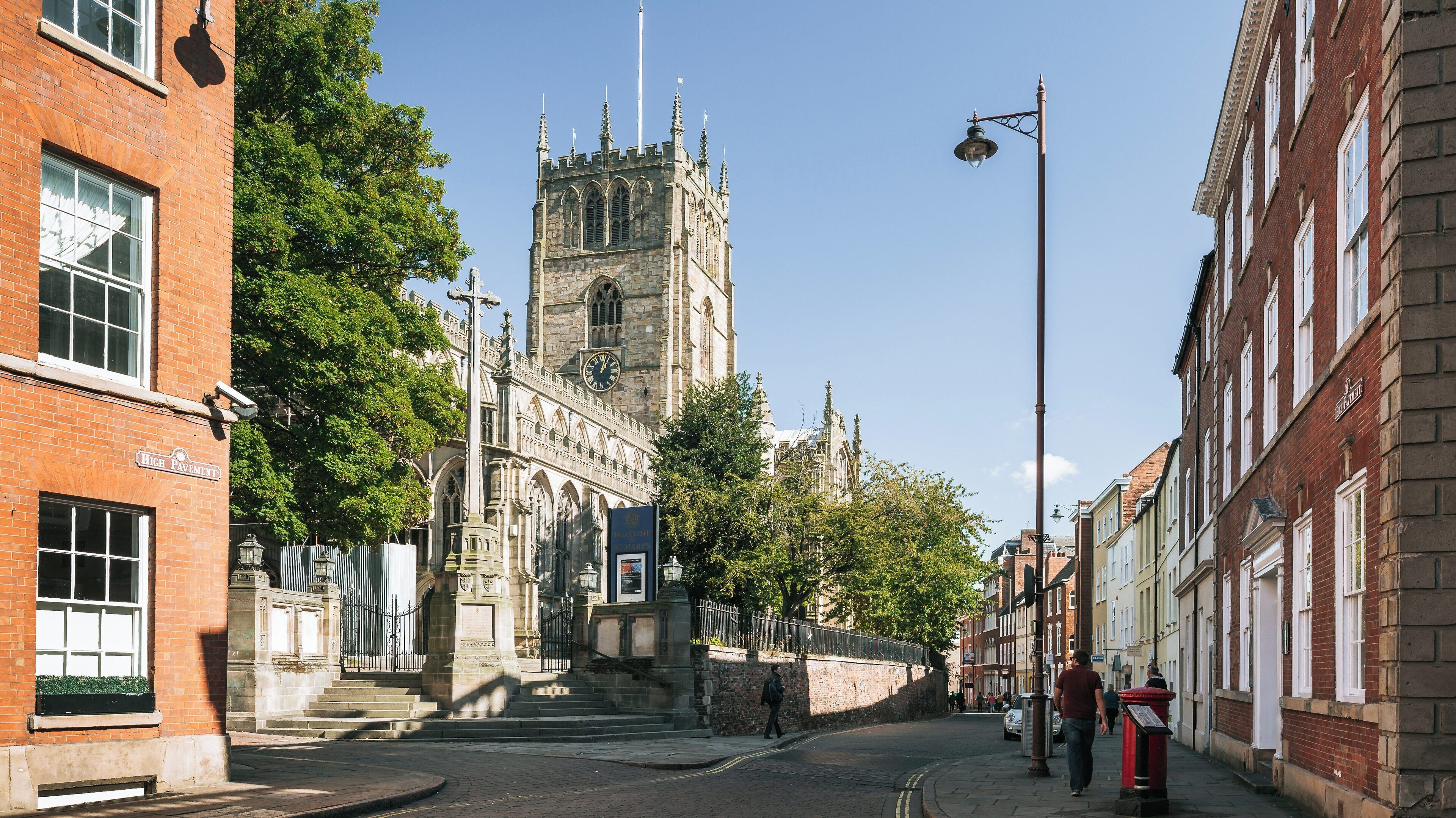 Discovering St Mary's Church in Lace Market, Nottingham, England, showcasing its majestic architecture and surrounding streets under a clear blue sky during the day