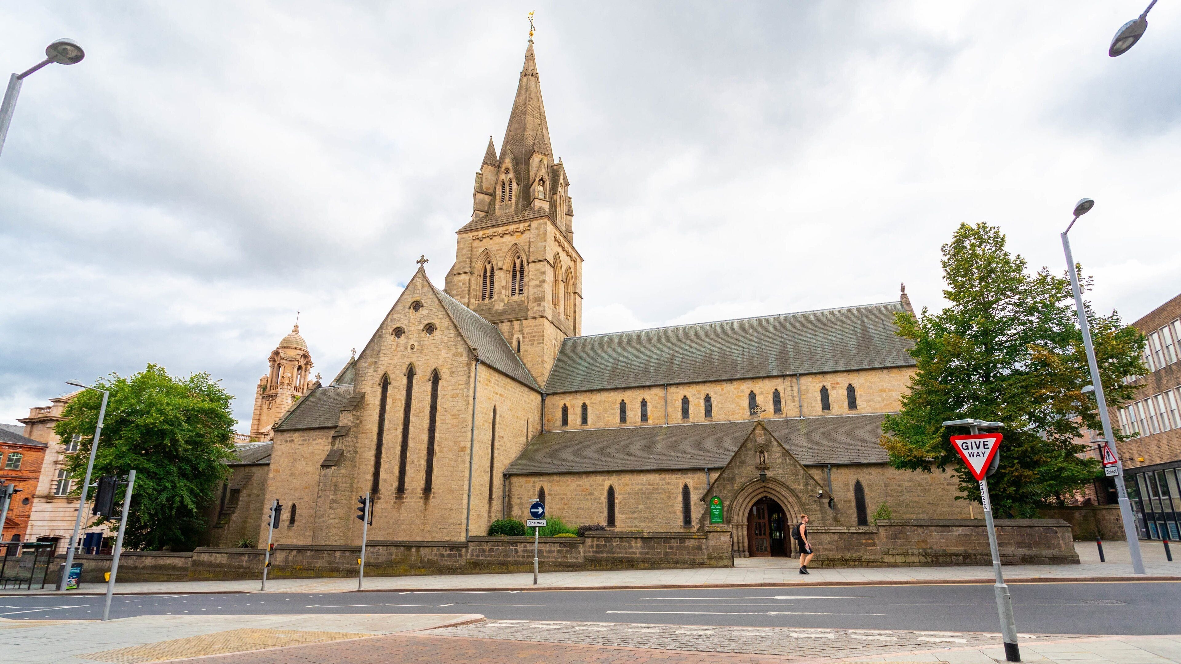 A historic church with a tall spire and a clock tower.