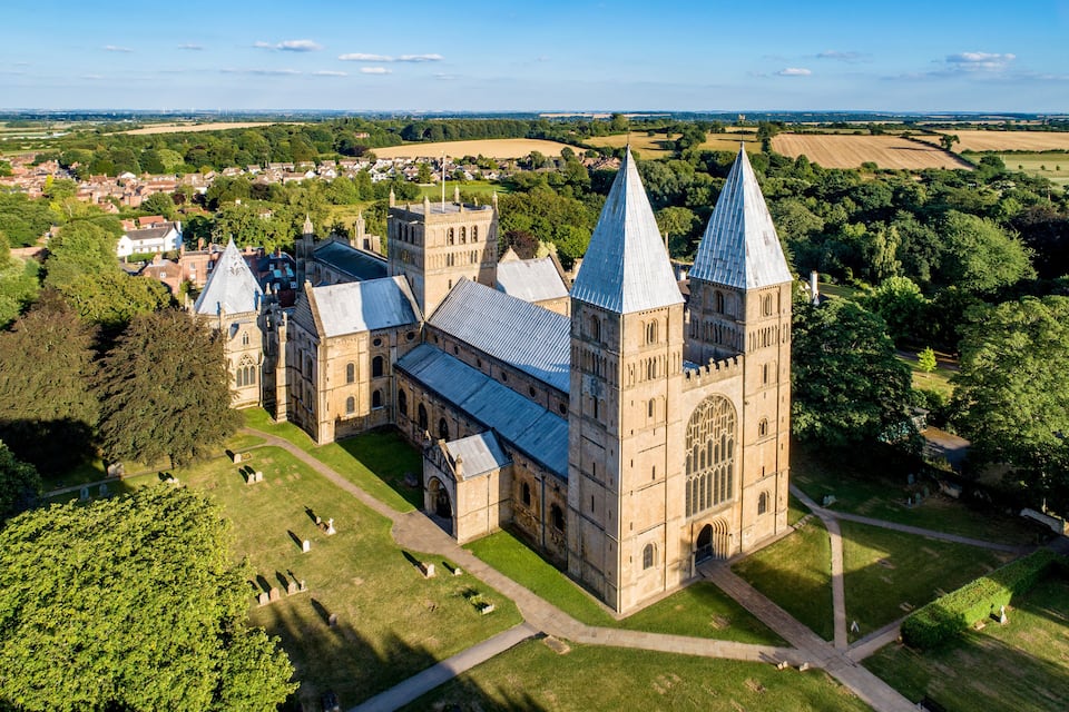 A large church with a prominent tower and a surrounding graveyard.