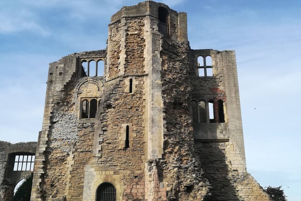 A historic stone castle with arched windows and a central tower.