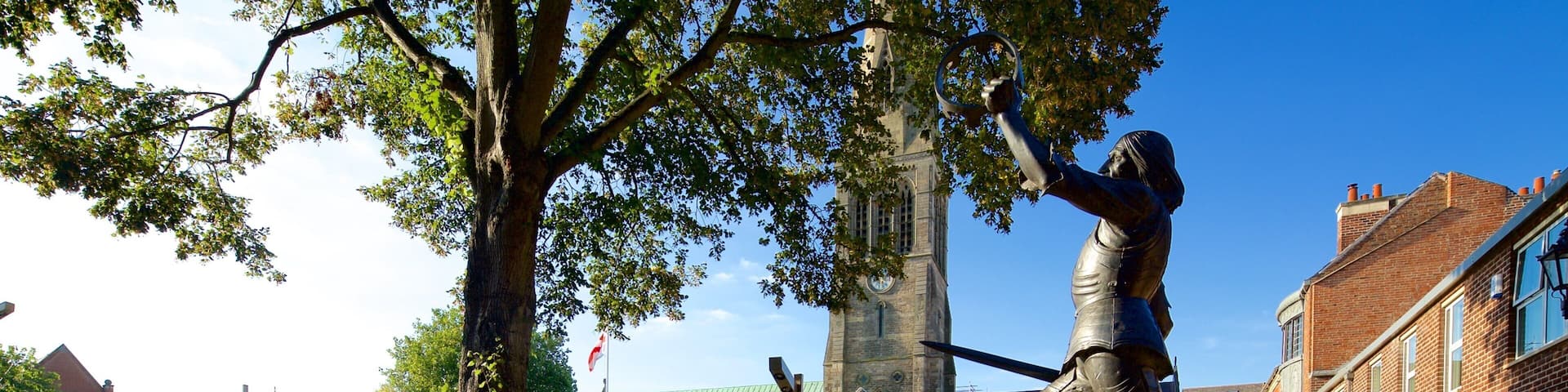 Leicester Cathedral which includes a statue or sculpture, a church or cathedral and a square or plaza