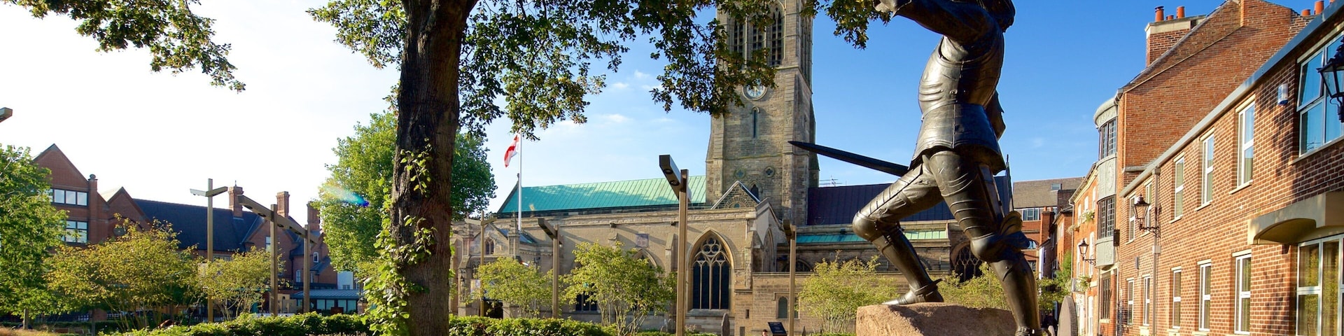 Leicester Cathedral which includes a statue or sculpture, a church or cathedral and a square or plaza