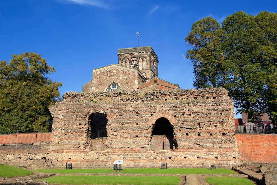 A historic stone structure with two arches and a clock tower.