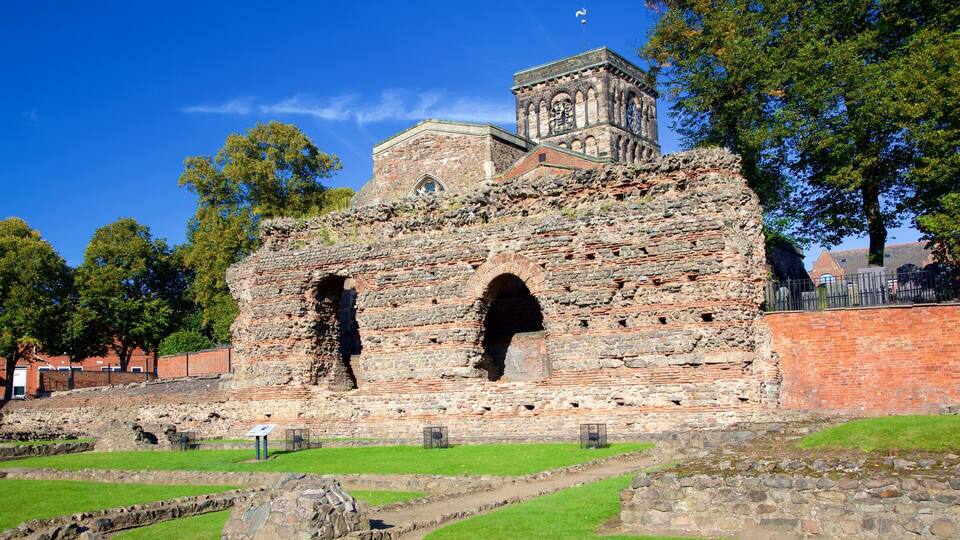 An ancient stone structure with two large arches and a clock tower.