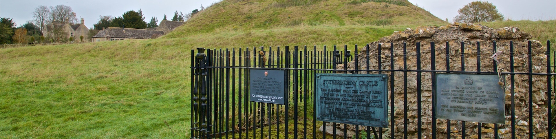 Fotheringhay Castle featuring a garden and signage