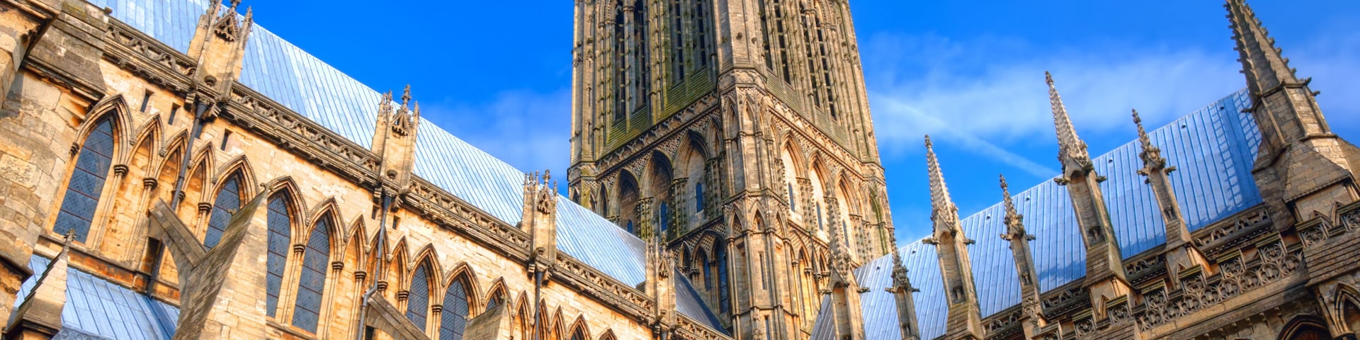 A historic cathedral with intricate Gothic architecture, including pointed arches and a tall spire.