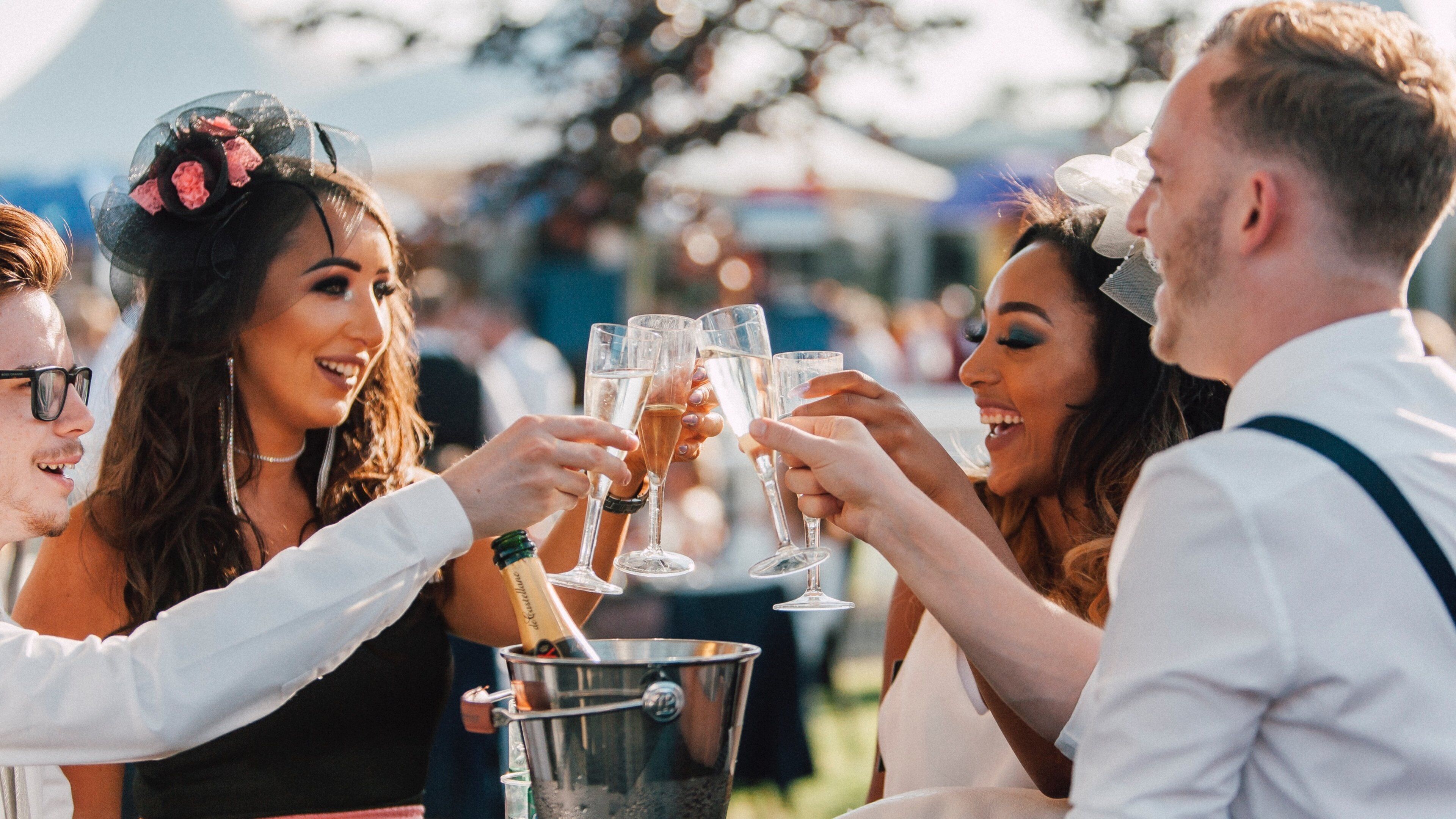 Chester Racecourse showing drinks or beverages as well as a small group of people