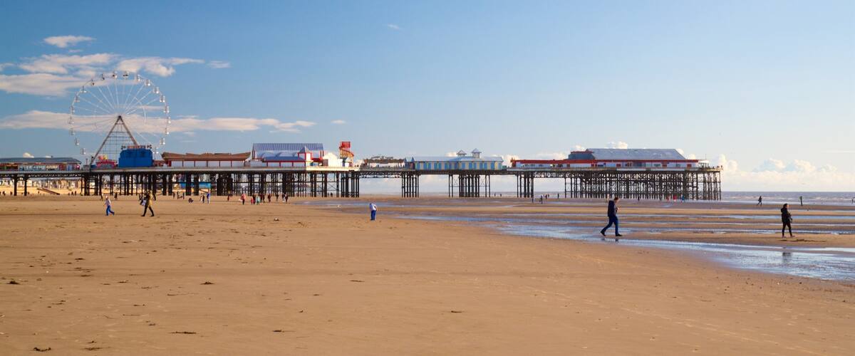 Blackpool Beach showing a beach and general coastal views as well as a small group of people