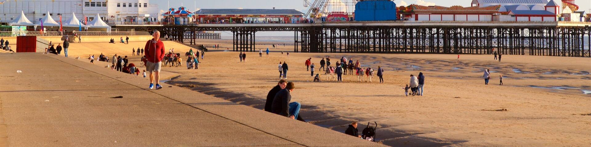 Blackpool Beach showing a beach and general coastal views as well as a small group of people