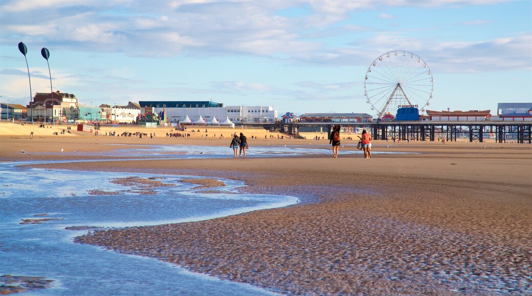 Blackpool Central Pier showing a beach and general coastal views as well as a small group of people