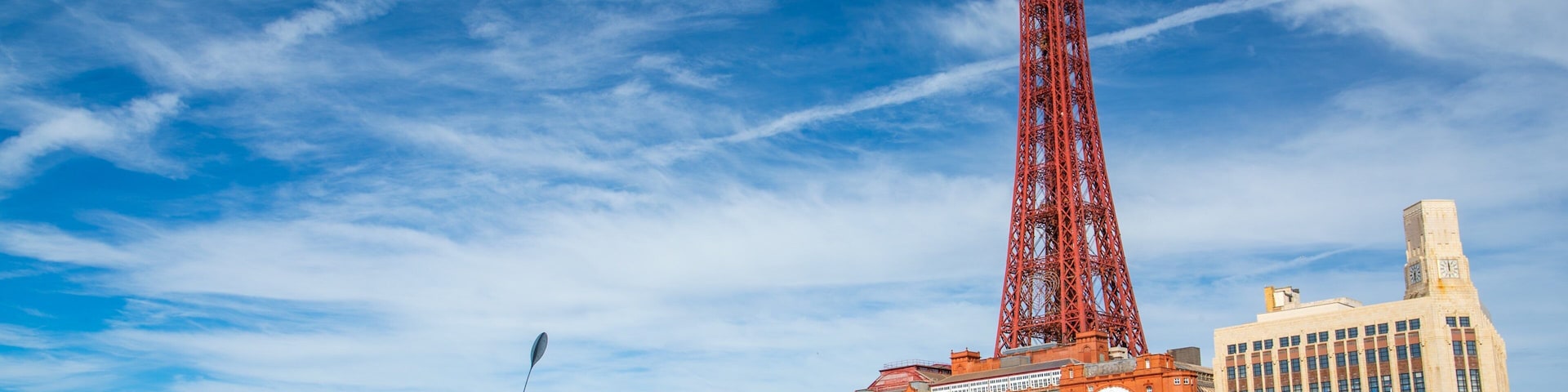 Blackpool which includes a coastal town and a sandy beach