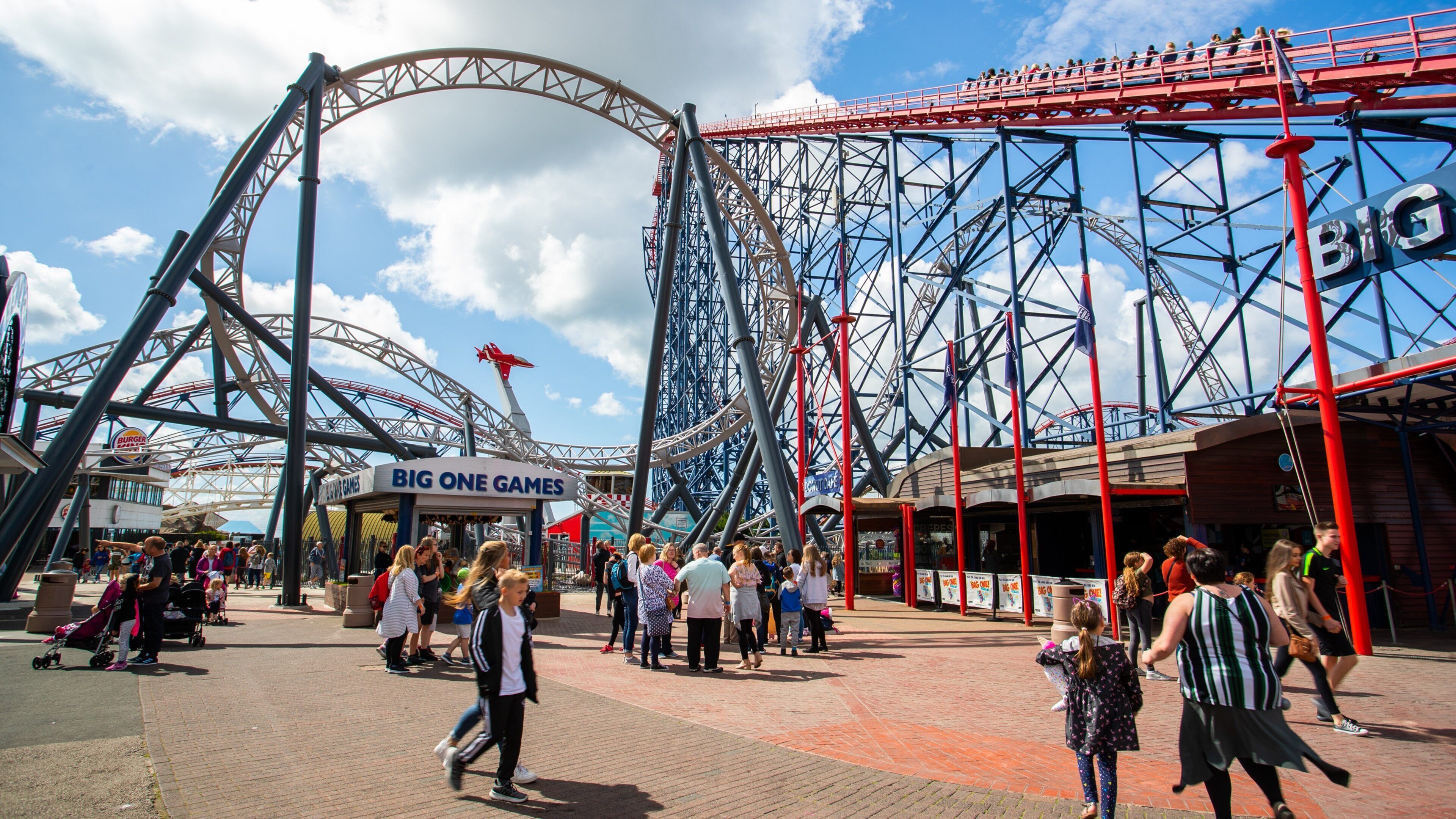 Blackpool Pleasure Beach featuring rides as well as a small group of people