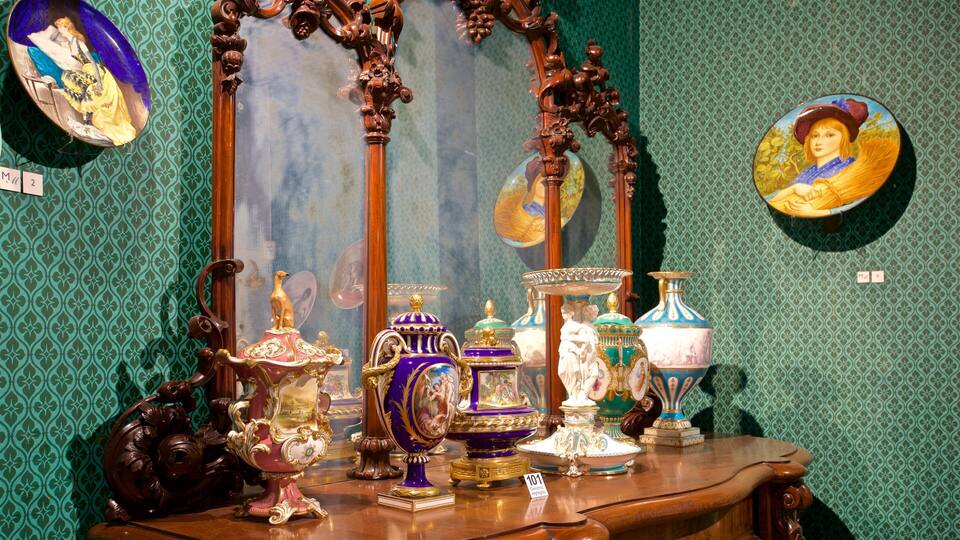 A display of ornate ceramic vases and a mirror with a decorative frame.