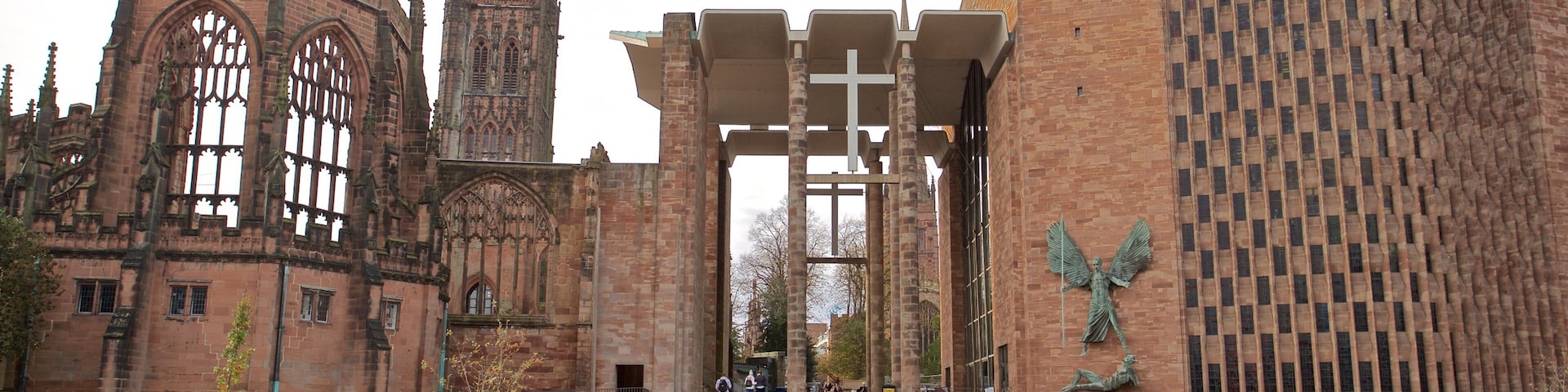 Coventry Cathedral showing a church or cathedral and heritage architecture as well as a small group of people