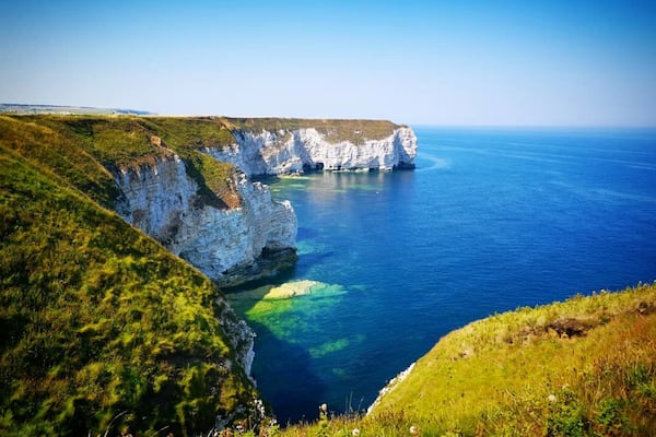 Flamborough Head is a promontory, 8 miles long on the Yorkshire coast of England, between the Filey and Bridlington bays of the North Sea. It is a chalk headland, with sheer white cliffs. The cliff top has two standing lighthouse towers, the oldest dating from 1669 and Flamborough Head Lighthouse built in 1806.