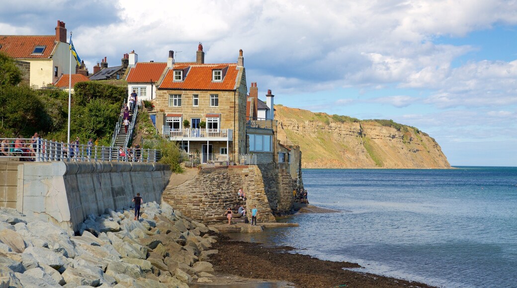 Robin Hood\'s Bay Beach featuring rocky coastline, a coastal town and general coastal views