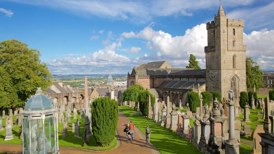 A historic church with a tall tower and a well-maintained graveyard.