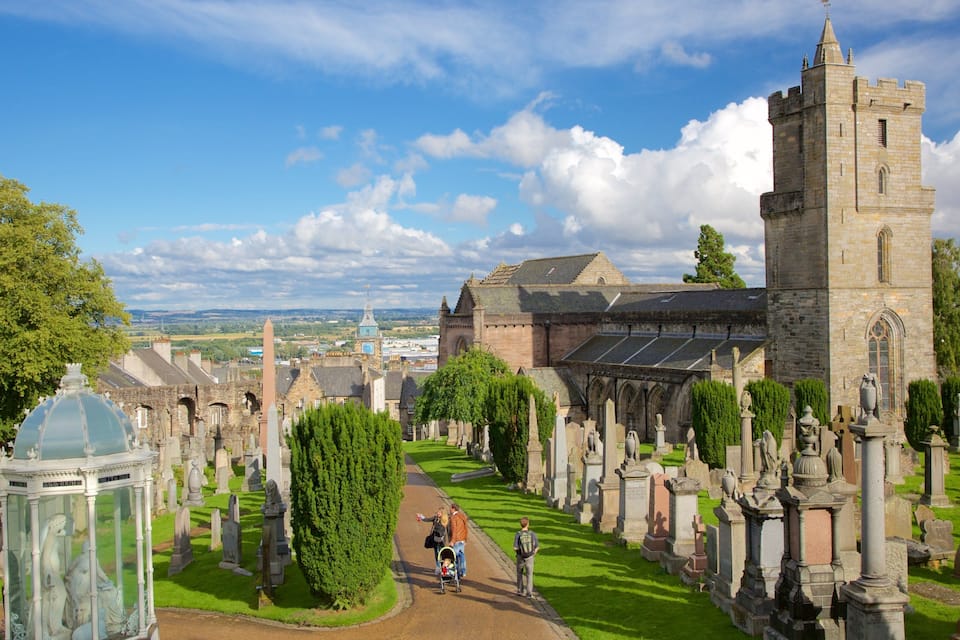 A historic church with a tall tower and a well-maintained graveyard.