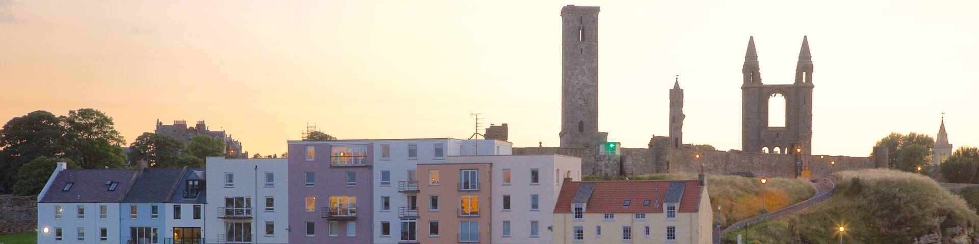St. Andrew\'s Cathedral which includes a beach, a sunset and a coastal town