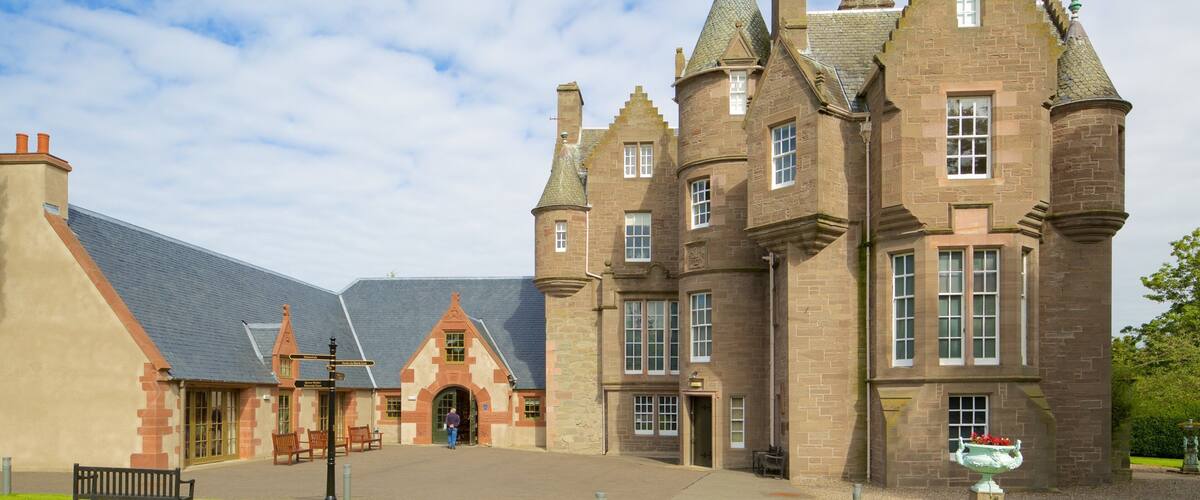 A historic building with multiple towers and a large entrance.