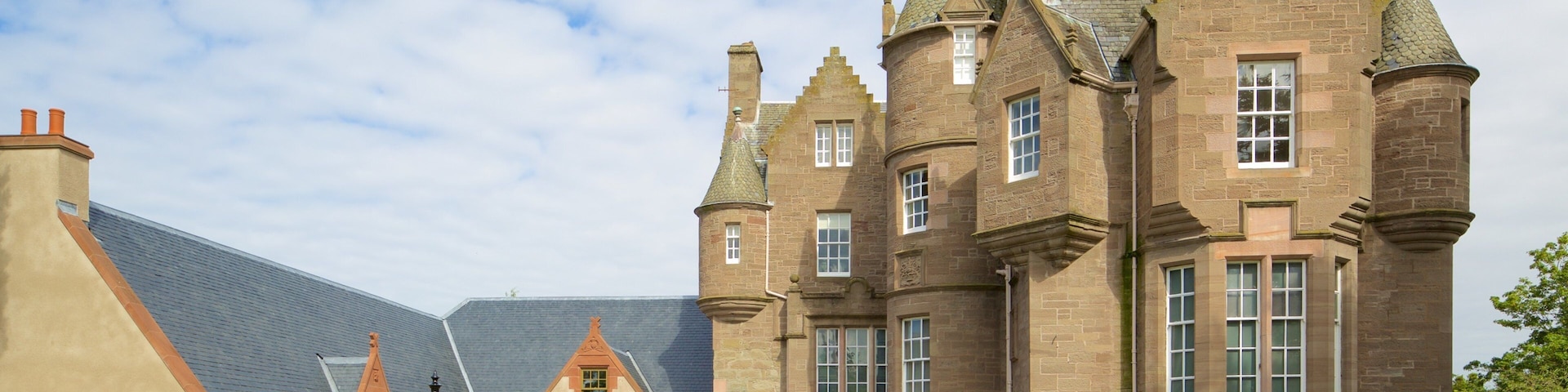 A historic building with multiple towers and a large entrance.