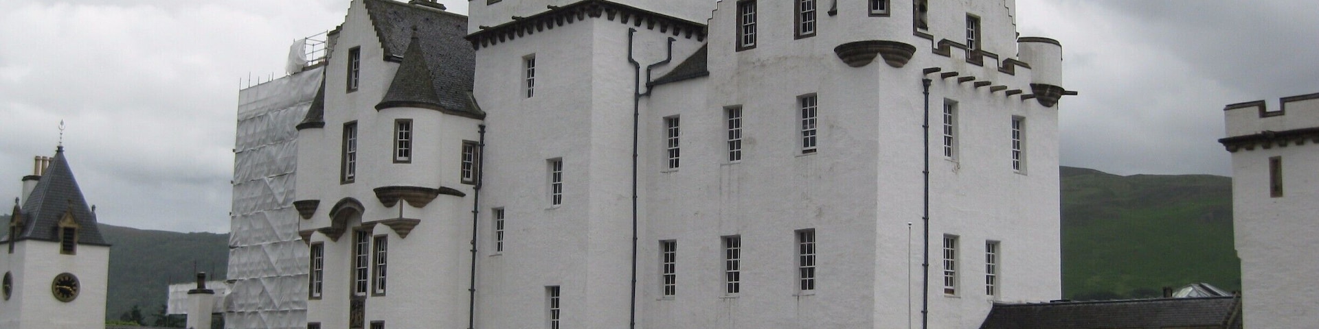 A large white castle with multiple towers and a flag.