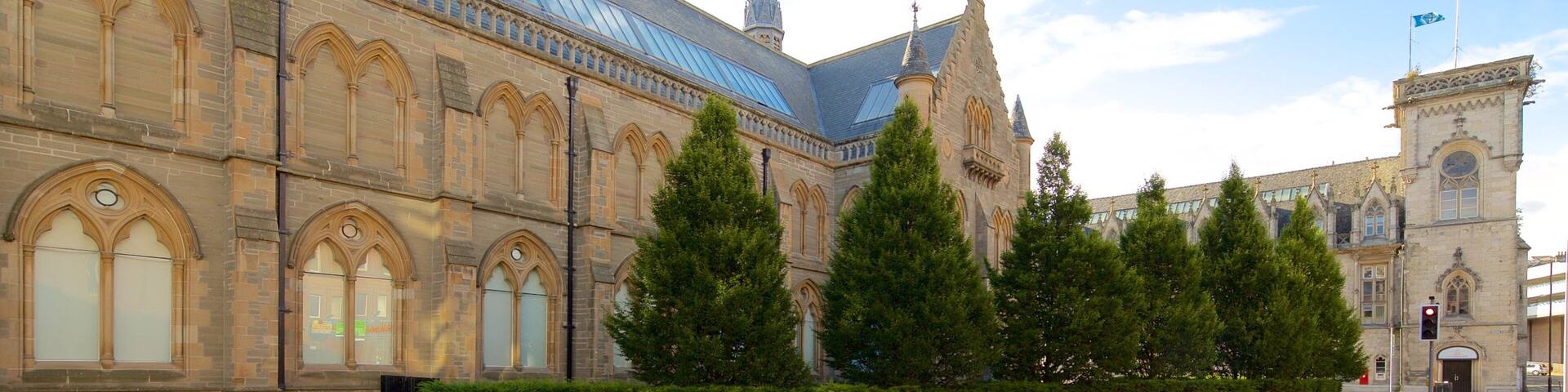 A historic building with arched windows and a tall spire.